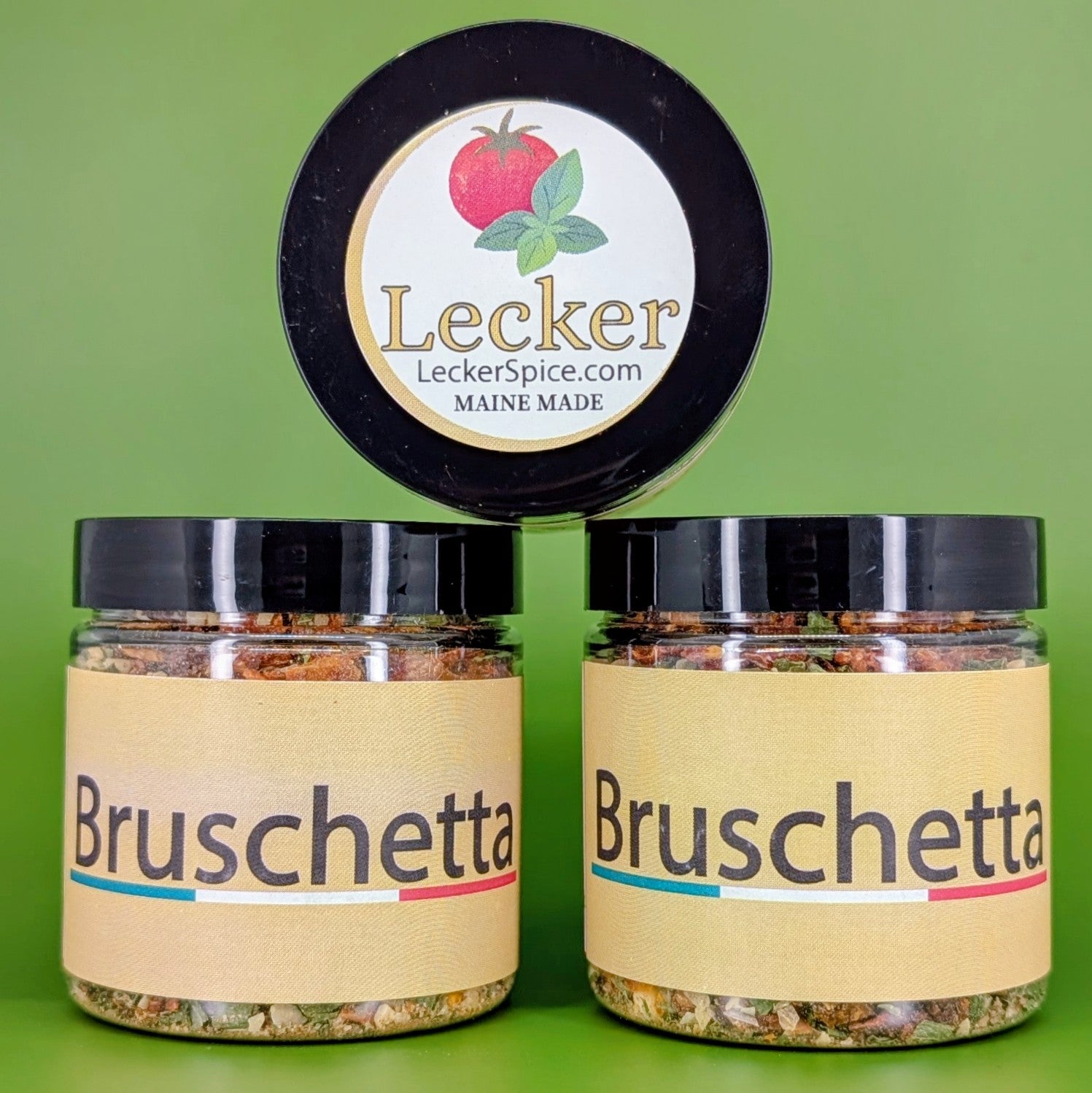 Three jars of Lecker Spice Bruschetta seasoning on a green background